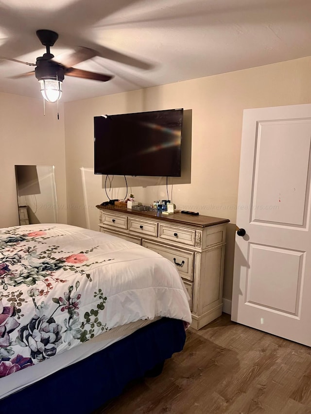 bedroom featuring ceiling fan and dark wood-type flooring