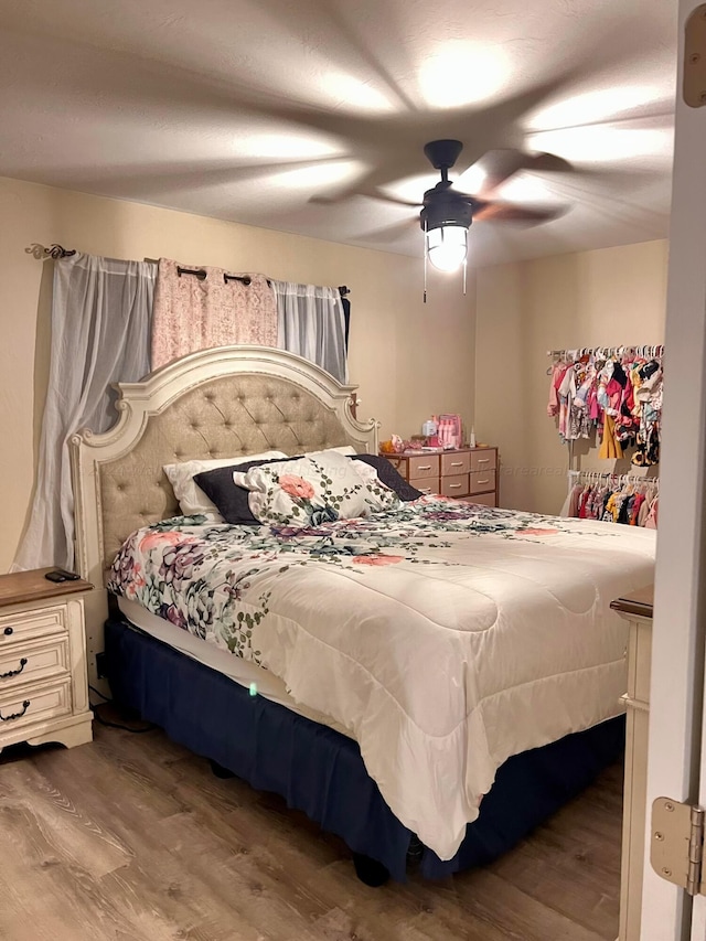 bedroom with wood-type flooring and ceiling fan