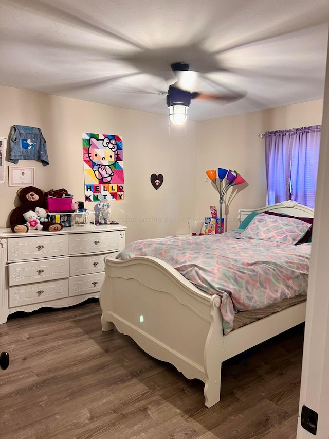 bedroom with ceiling fan and dark hardwood / wood-style flooring