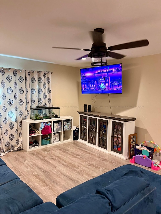 living room with ceiling fan and wood-type flooring