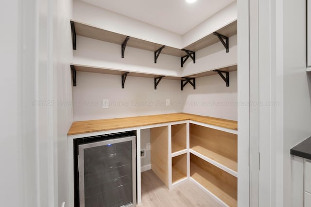 storage area featuring wine cooler