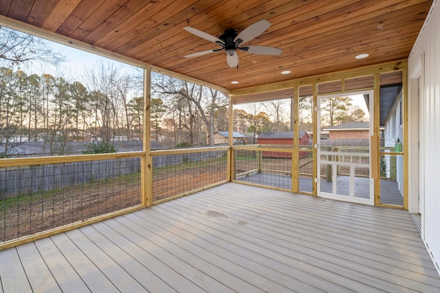 unfurnished sunroom with wooden ceiling and a ceiling fan