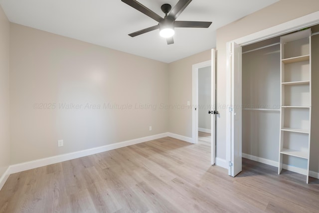 unfurnished bedroom featuring light wood-style floors, baseboards, and a closet