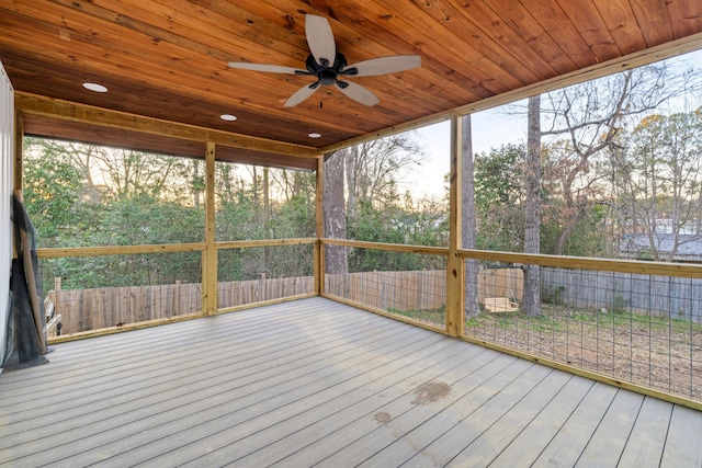 unfurnished sunroom with ceiling fan and wooden ceiling