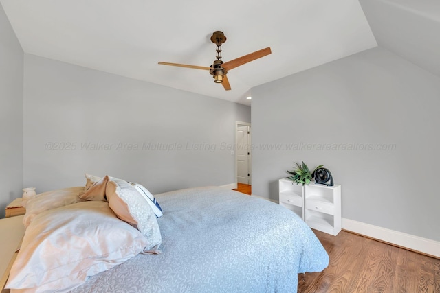 bedroom with lofted ceiling, wood finished floors, a ceiling fan, and baseboards