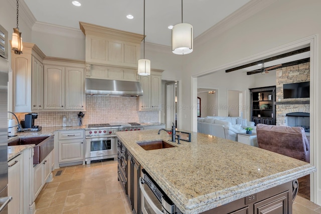 kitchen with beamed ceiling, high end stainless steel range, a sink, under cabinet range hood, and backsplash