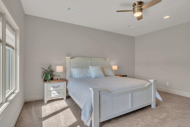 carpeted bedroom featuring visible vents, ceiling fan, and baseboards