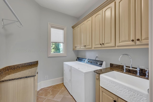 laundry room with independent washer and dryer, cabinet space, a sink, and baseboards