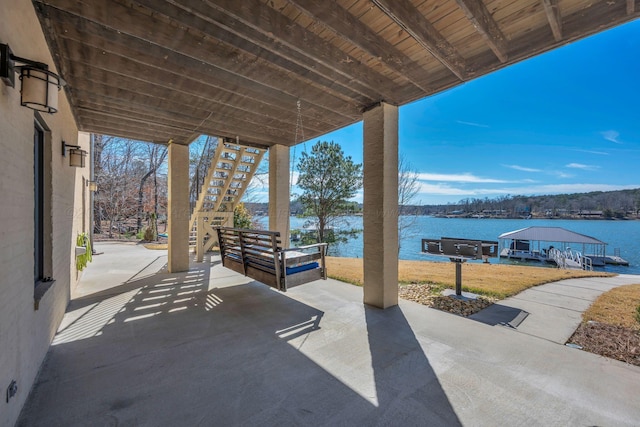 view of patio featuring a water view and stairs