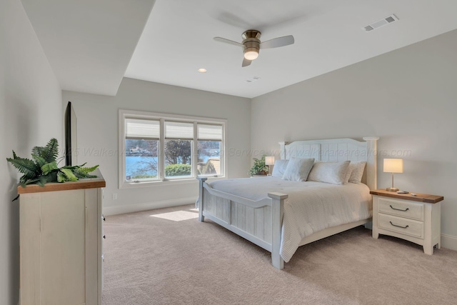 bedroom with baseboards, ceiling fan, visible vents, and light colored carpet