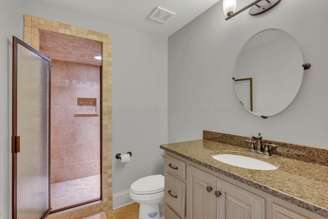 bathroom featuring toilet, a stall shower, vanity, and visible vents