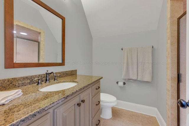 bathroom with baseboards, lofted ceiling, toilet, tile patterned flooring, and vanity