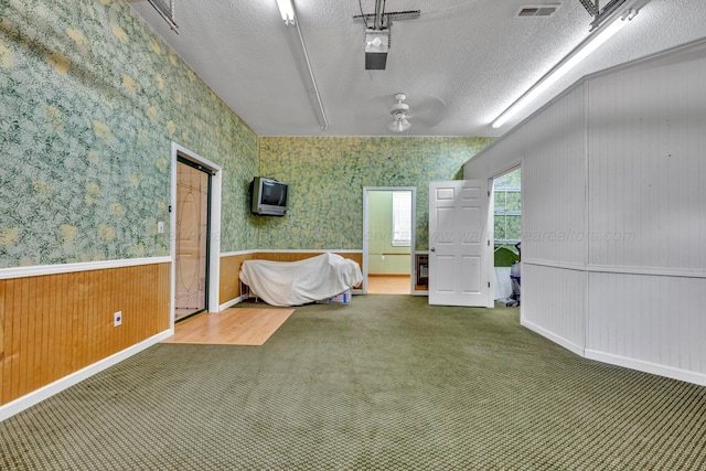 interior space featuring carpet floors and a textured ceiling