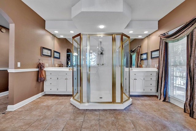 bathroom with tile patterned flooring, vanity, and an enclosed shower