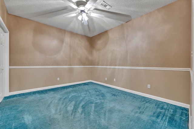 carpeted spare room with ceiling fan and a textured ceiling