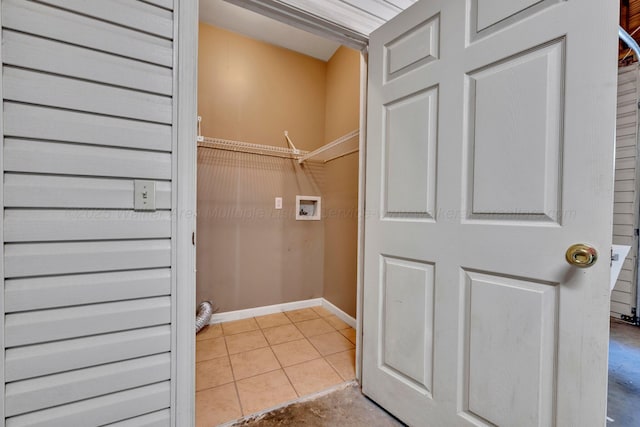 clothes washing area featuring washer hookup and light tile patterned floors