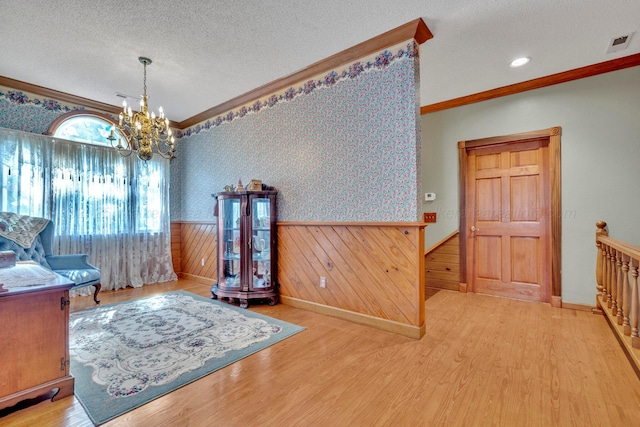 office space with ornamental molding, a chandelier, hardwood / wood-style floors, and a textured ceiling