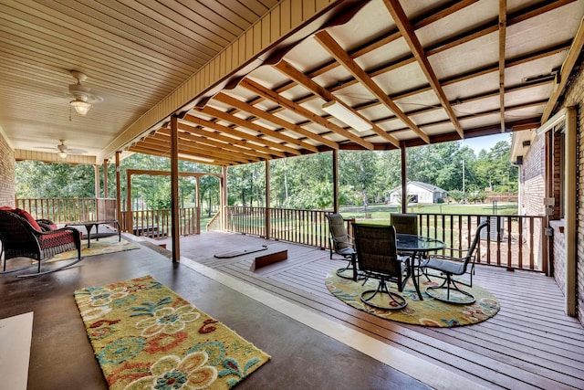 deck with ceiling fan and a yard