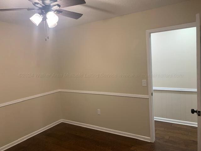 unfurnished room featuring ceiling fan and dark hardwood / wood-style floors