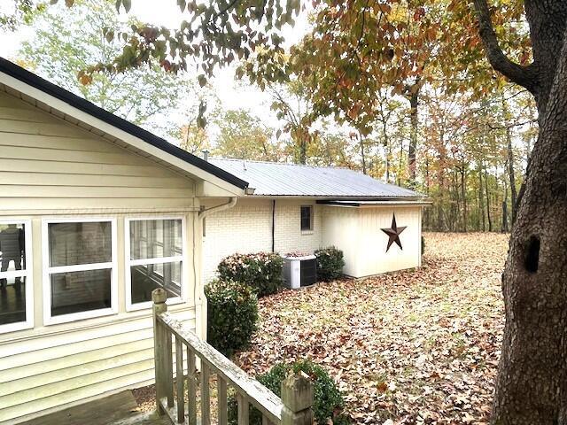 view of side of property featuring central AC