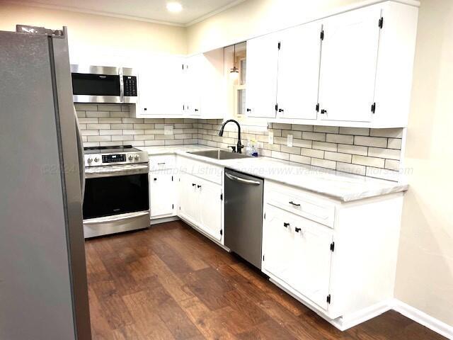 kitchen featuring sink, white cabinets, stainless steel appliances, and dark hardwood / wood-style floors