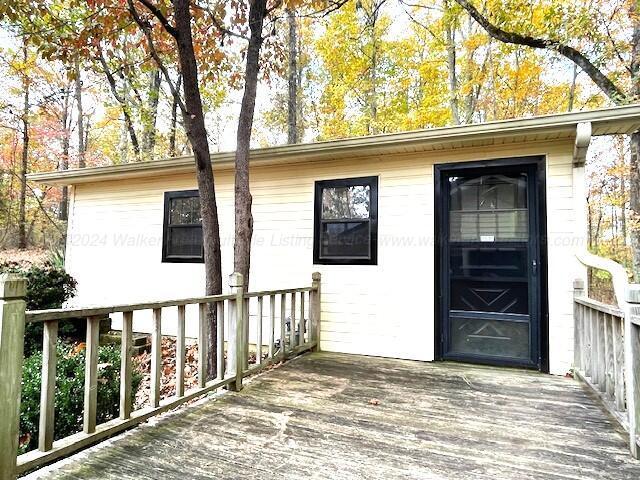 entrance to property featuring a wooden deck