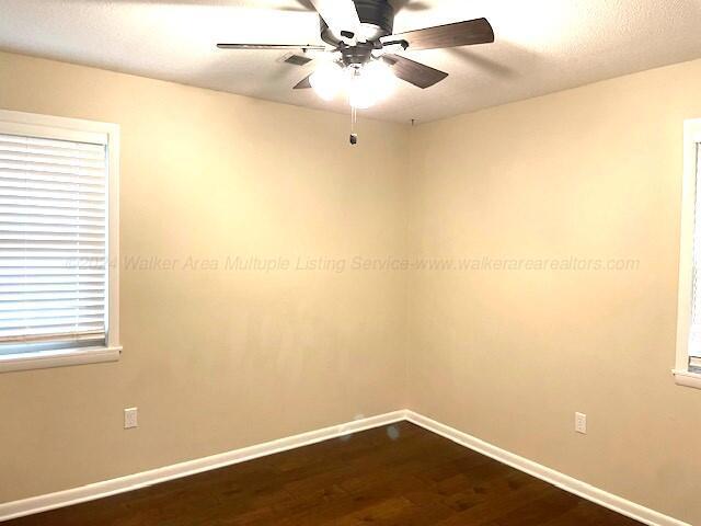 unfurnished room with hardwood / wood-style floors and ceiling fan