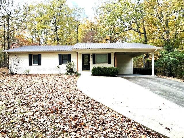 ranch-style home with a carport