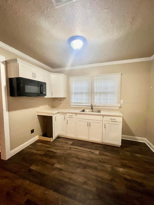 kitchen with dark hardwood / wood-style flooring, sink, white cabinets, and ornamental molding