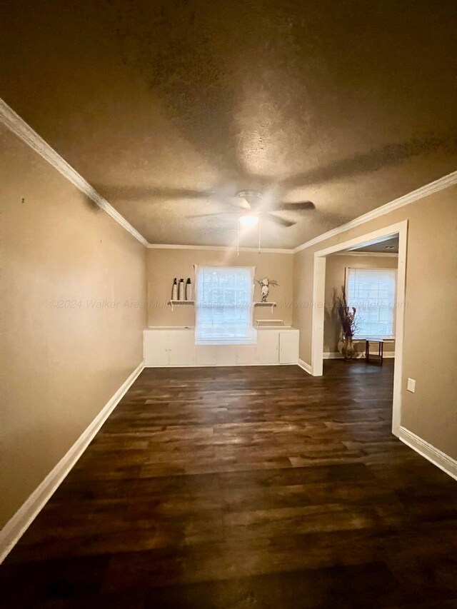 additional living space with a healthy amount of sunlight and dark wood-type flooring