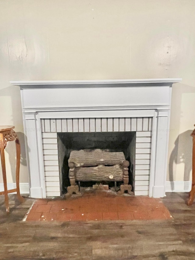 interior details featuring hardwood / wood-style flooring and a fireplace