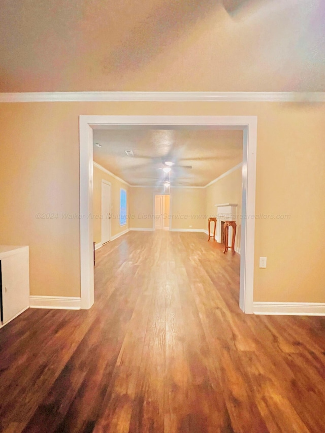 unfurnished living room featuring hardwood / wood-style floors, ceiling fan, and crown molding