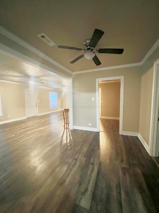 unfurnished room featuring dark hardwood / wood-style flooring, ceiling fan, and crown molding