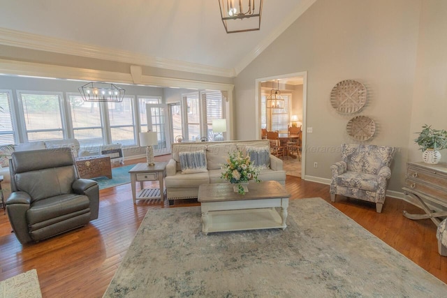 living room with a healthy amount of sunlight, dark hardwood / wood-style floors, and an inviting chandelier