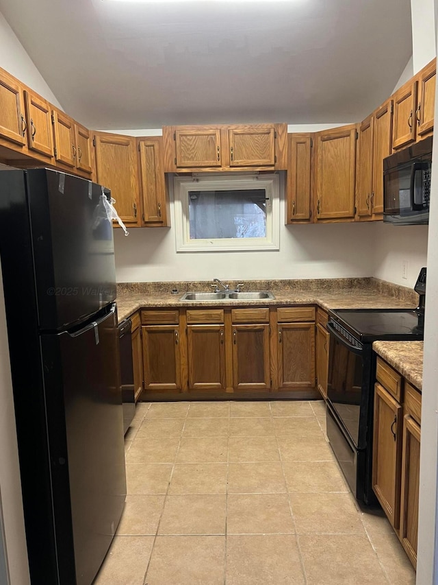 kitchen featuring lofted ceiling, sink, light stone counters, light tile patterned floors, and black appliances