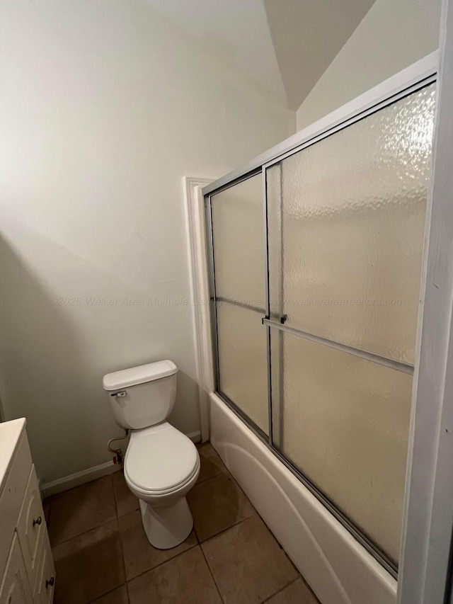 full bathroom featuring tile patterned floors, toilet, combined bath / shower with glass door, and vanity