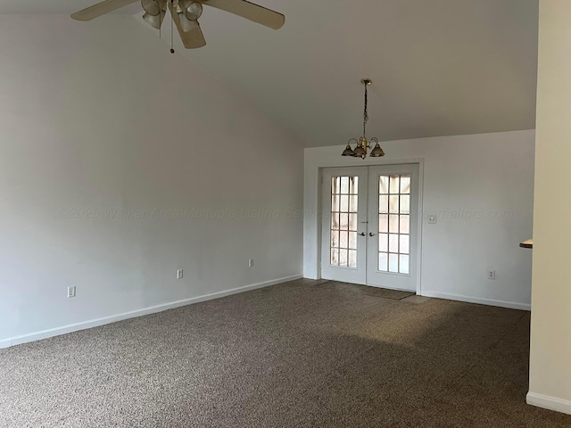 empty room with french doors, ceiling fan, lofted ceiling, and dark carpet