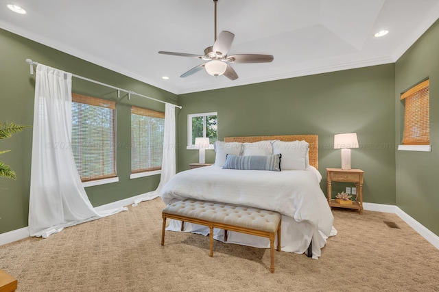 carpeted bedroom with ceiling fan and ornamental molding