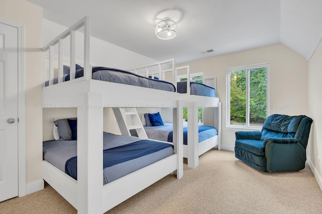 bedroom featuring carpet and lofted ceiling