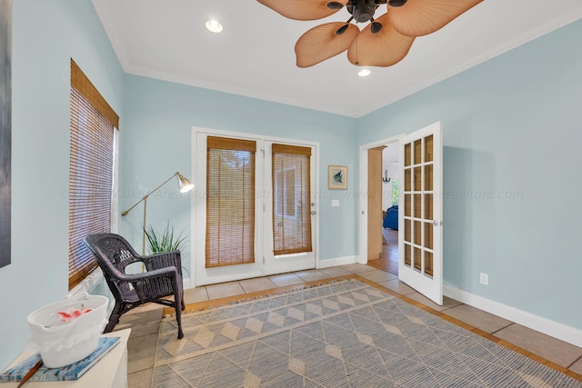 interior space with tile patterned floors, ceiling fan, french doors, and crown molding