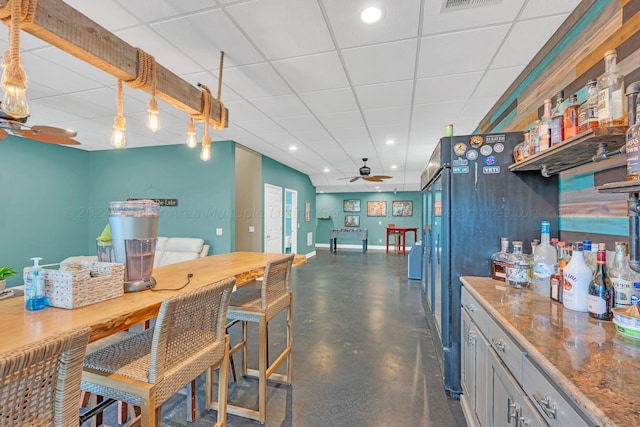 kitchen featuring a drop ceiling and ceiling fan