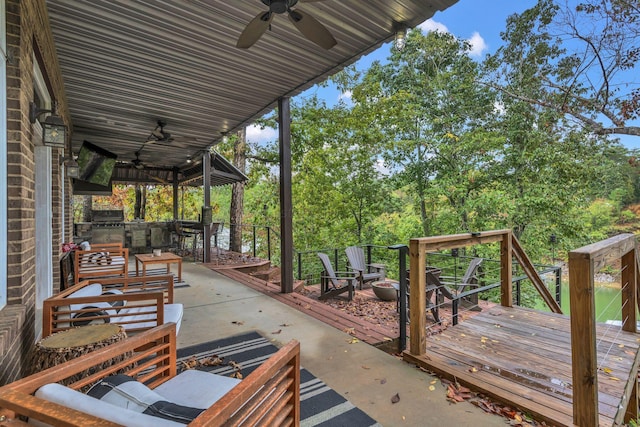 view of patio with a wooden deck, ceiling fan, exterior kitchen, and an outdoor hangout area