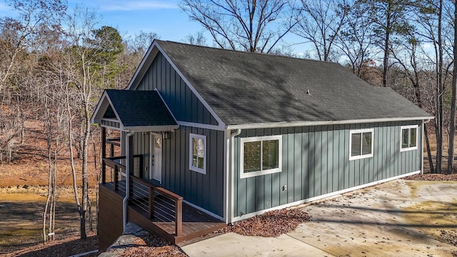 view of property exterior featuring board and batten siding and a shingled roof