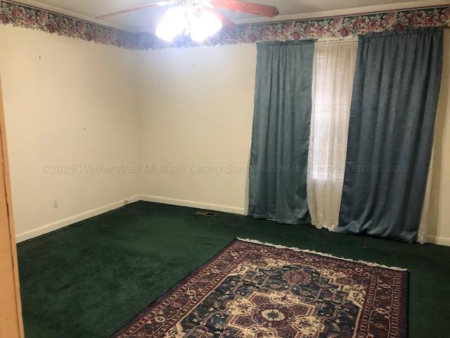 unfurnished room with ceiling fan, carpet floors, and baseboards