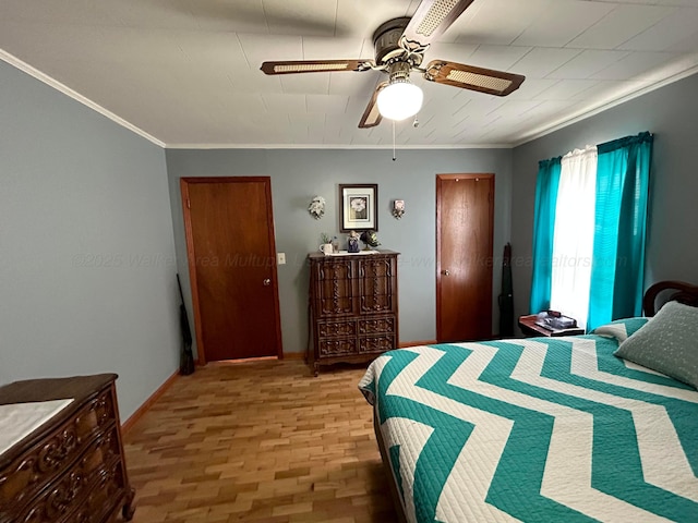 bedroom with baseboards, ceiling fan, and crown molding