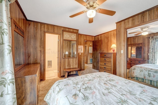 bedroom featuring ornamental molding, wooden walls, and light carpet