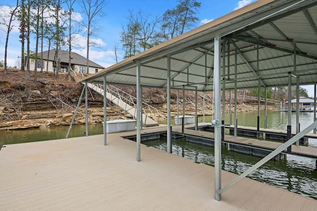 dock area featuring boat lift and a water view