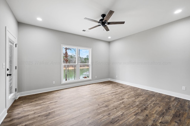 empty room featuring visible vents, wood finished floors, ceiling fan, and recessed lighting