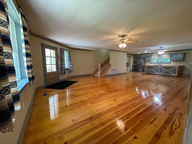 4694 County Road 1718, Holly Pond, AL 35083 - unfurnished living room featuring wood-type flooring, ceiling fan, and stairs
