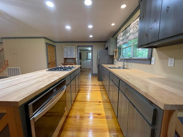 4694 County Road 1718, Holly Pond, AL 35083 - kitchen with butcher block countertops, appliances with stainless steel finishes, light wood-type flooring, recessed lighting, and a center island